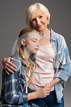 Portrait of happy grandmother and granddaughter embracing