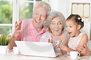 Grandparents and child singing karaoke