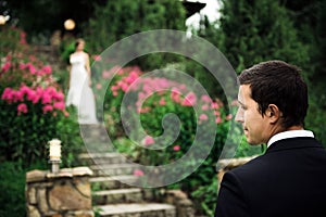 Portrait of a happy groom waiting for his bride