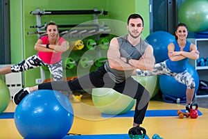 Portrait of happy group exercising on Swiss ball