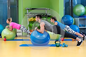 Portrait of happy group exercising on Swiss ball