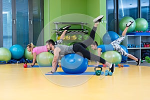 Portrait of happy group exercising on Swiss ball