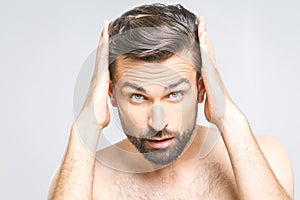 Portrait of happy healthy man combing his hair with fingers