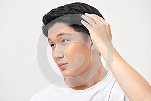 Portrait of happy healthy man combing his hair with fingers