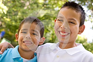 Portrait of happy Hispanic brothers outside.