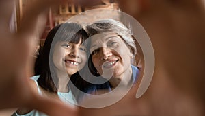 Portrait of happy Hispanic grandmother and little granddaughter