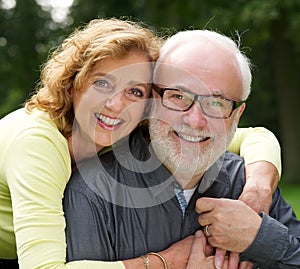 Portrait of a happy husband and wife smiling outdoors photo