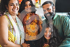 Portrait of happy indian family - Sotuhern asian mother, father, daughter and son smiling in front of camera - Cheerful people and