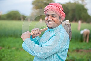 Portrait of happy indian male farmer labor worker holding Pretail Garden Spade Shovel or agricultural tool