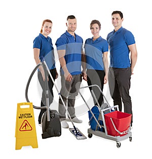 Portrait Of Happy Janitors With Cleaning Equipments