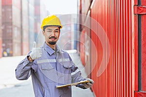 Portrait happy Japanese male engineer worker working in container port cargo. Japan shipping logistics industry customs staff