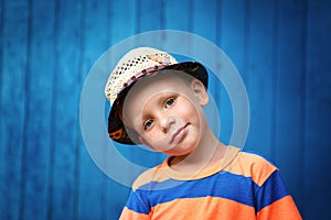 Portrait of happy joyful beautiful little boy wearing a straw ha