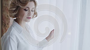 Portrait of happy lady smiling at camera at light window in room