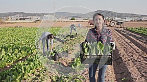 Portrait of happy latino woman with ripe mangold in their hands