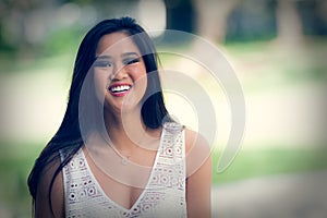 Portrait of a happy laughing Asian young woman - filter