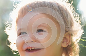 Portrait of a happy laughing baby child. Close up positive kids macro face. Kids smiling, cute smile.