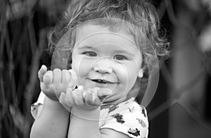 Portrait of a happy laughing baby child on playground. Close up positive kids face.