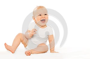 Portrait of happy laughing baby in white bodysuit