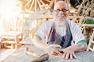 portrait happy leather maker artist handcraft working at own workshop small studio made by order masterwork piece photo