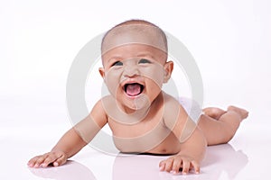 Portrait of happy little asian baby girl smile face down on white floor