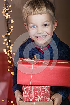 Portrait of a happy little boy holding a new gift. Christmas. Birthday