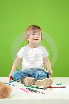 Portrait of happy little boy over green background