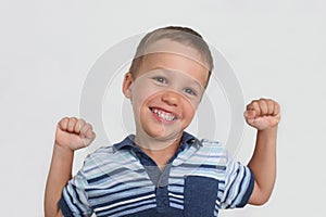 happy little boy showing strong fists photo