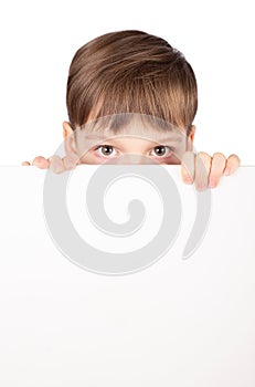 Portrait of happy little boy with white blank