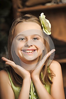 Portrait of a happy little girl in a green dress