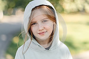 Portrait of happy little girl in hoodie