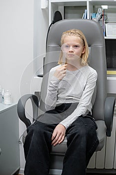 portrait happy little girl patient ophthalmology clinic, vision test in progress cheerful child an optometric
