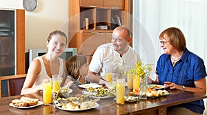 Portrait of happy lovely three generations family together around festive table