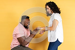 Happy couple standing together romantic man puts on a wedding ring to her girlfriend making proposal