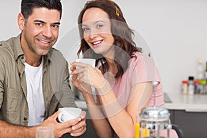 Portrait of a happy loving couple with coffee cup