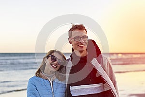 Portrait of happy loving couple on sunset background over sea.