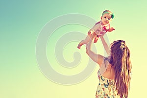 Portrait of happy loving mother and her baby outdoors. Mother and child in summer