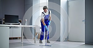 Portrait Of Happy Male Janitor Cleaning Floor