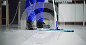 Portrait Of Happy Male Janitor Cleaning Floor