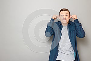 Portrait of happy man fooling around and making funny goofy face