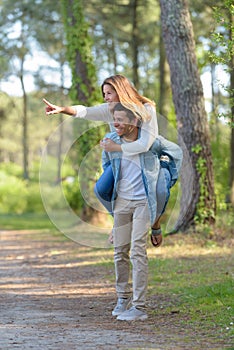 portrait happy man giving piggy bag to woman