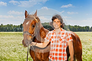 Portrait of happy man with his beautiful bay horse