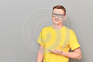 Portrait of happy man pointing with one hand at copy space and smiling