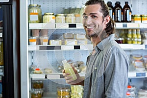 Portrait of happy man shopping for groceries