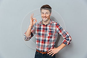 Portrait of a happy man showing okay gesture