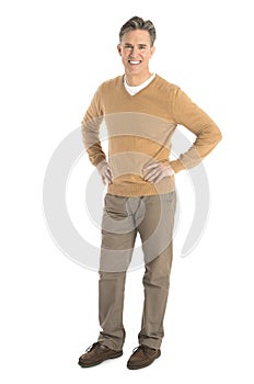 Portrait Of Happy Man Standing With Hand On Hips photo