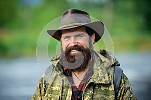 Portrait of happy man traveler with backpack hiking outdoor. Travel lifestyle countryside and adventure concept