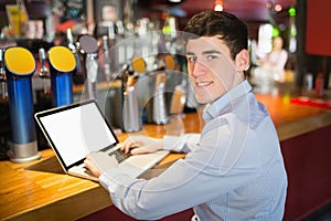 Portrait of happy man using laptop