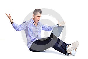 Portrait of happy man working on laptop in casuals photo