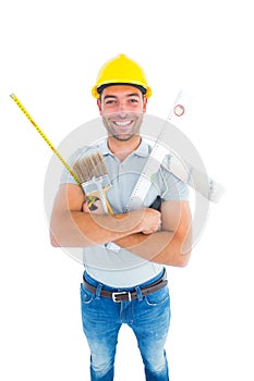 Portrait of happy manual worker holding various tools