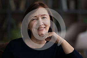 Portrait of happy mature 60s woman feel optimistic